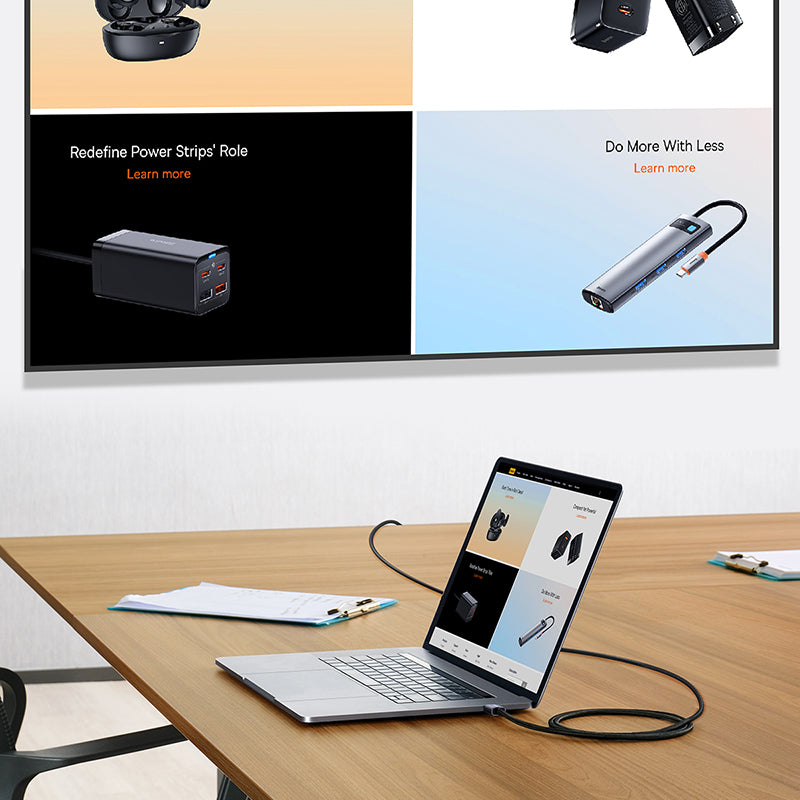Laptop on a desk with power strips displayed on a screen in the background