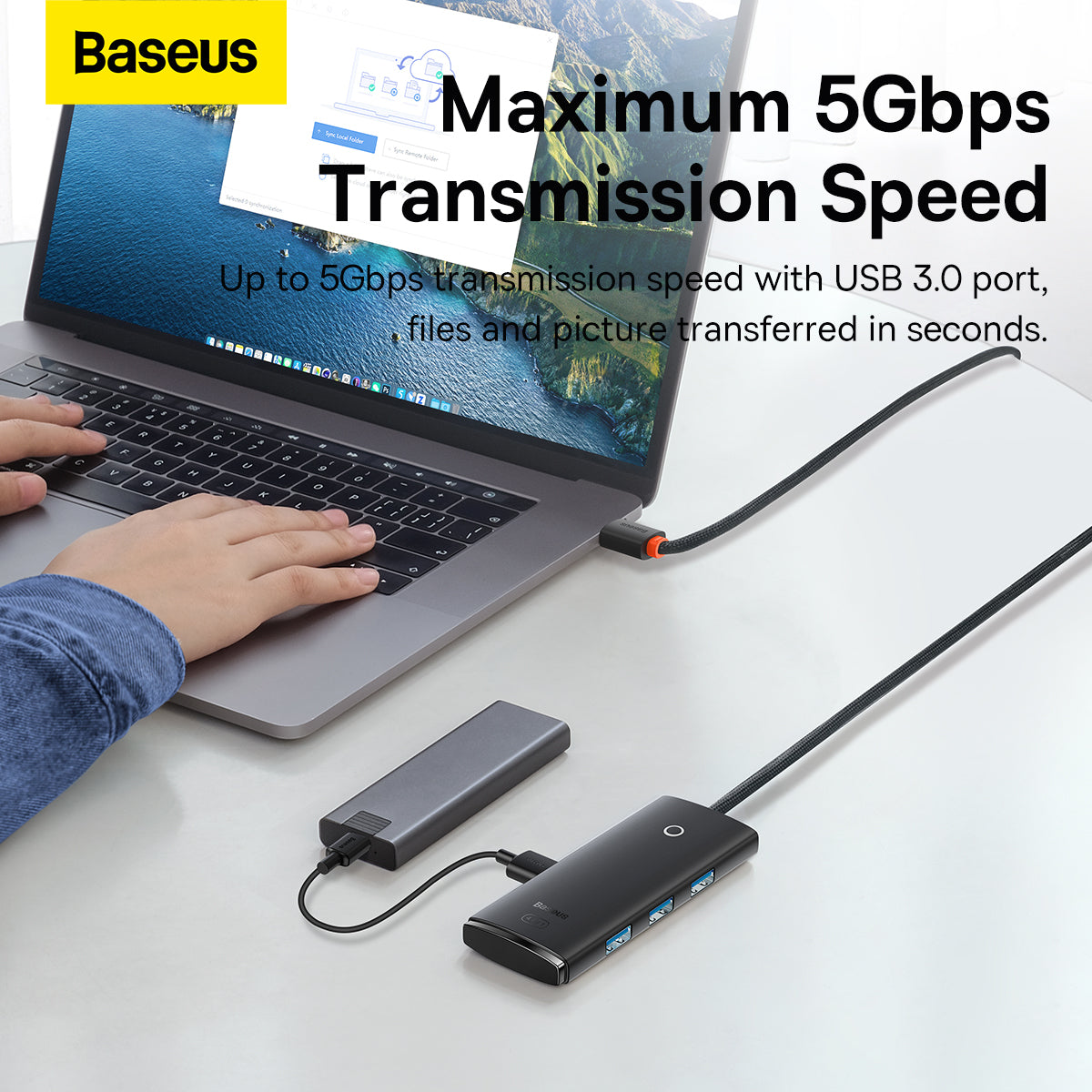 Laptop with USB hub and cable, Baseus branding visible, on a white surface.