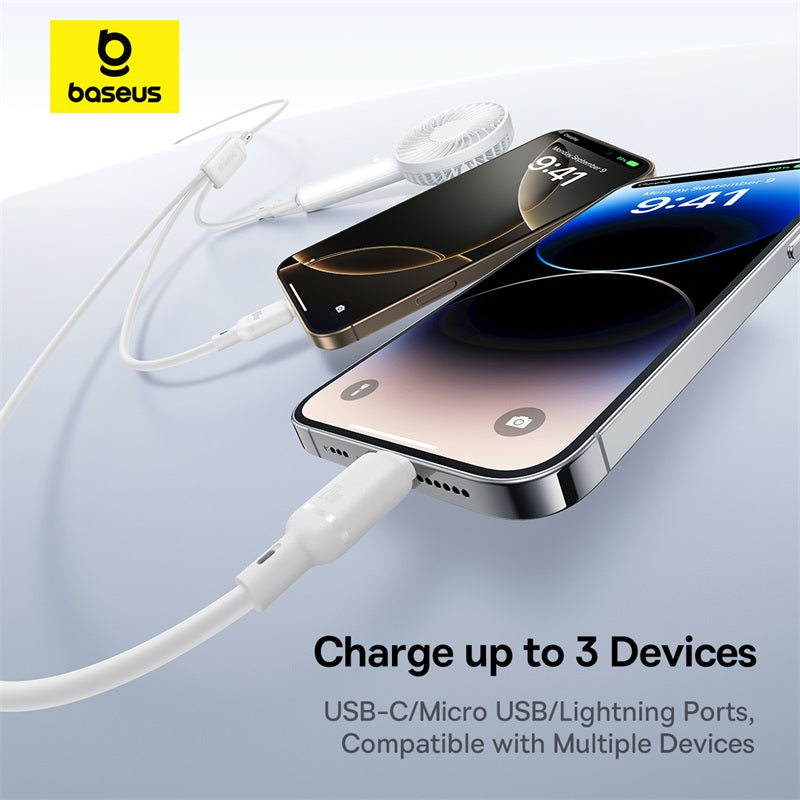 Baseus multi-device charging cable shown with two smartphones and a small white fan on a light blue gradient background, with text reading 'Charge up to 3 Devices' and 'USB-C/Micro USB/Lightning Ports, Compatible with Multiple Devices.'.