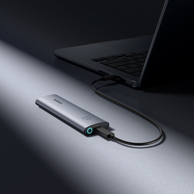 USB adapter connected to a laptop on a dark surface