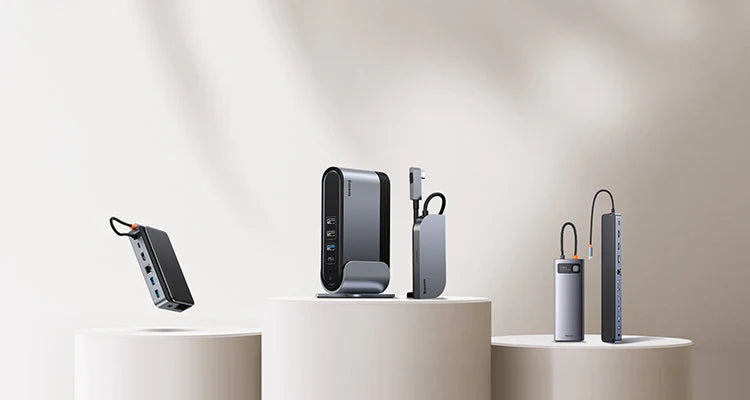 Collection of electronic devices on white cylindrical stands against a neutral background