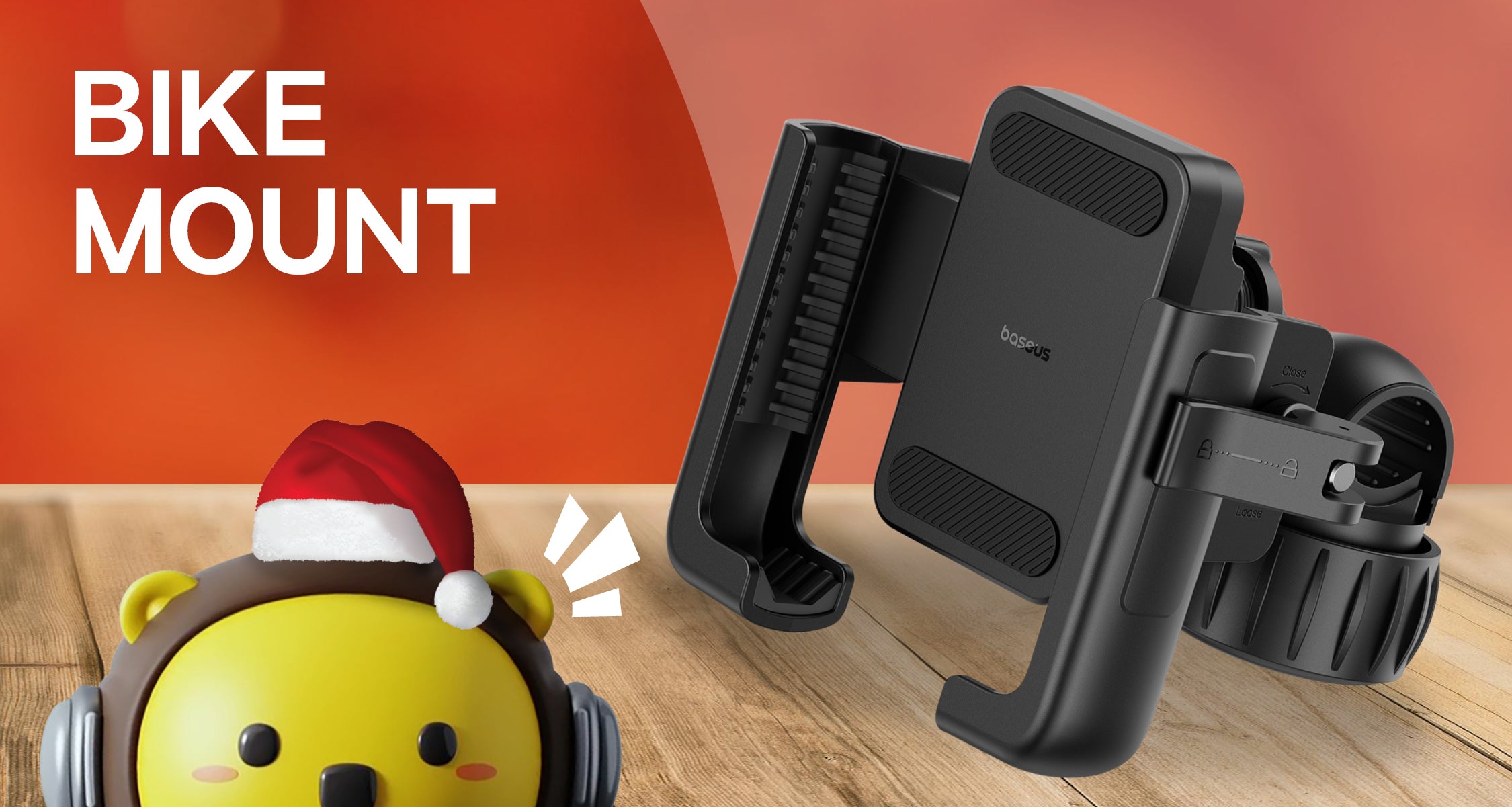 Black bike mount with a yellow character wearing headphones and a Santa hat on a wooden surface.