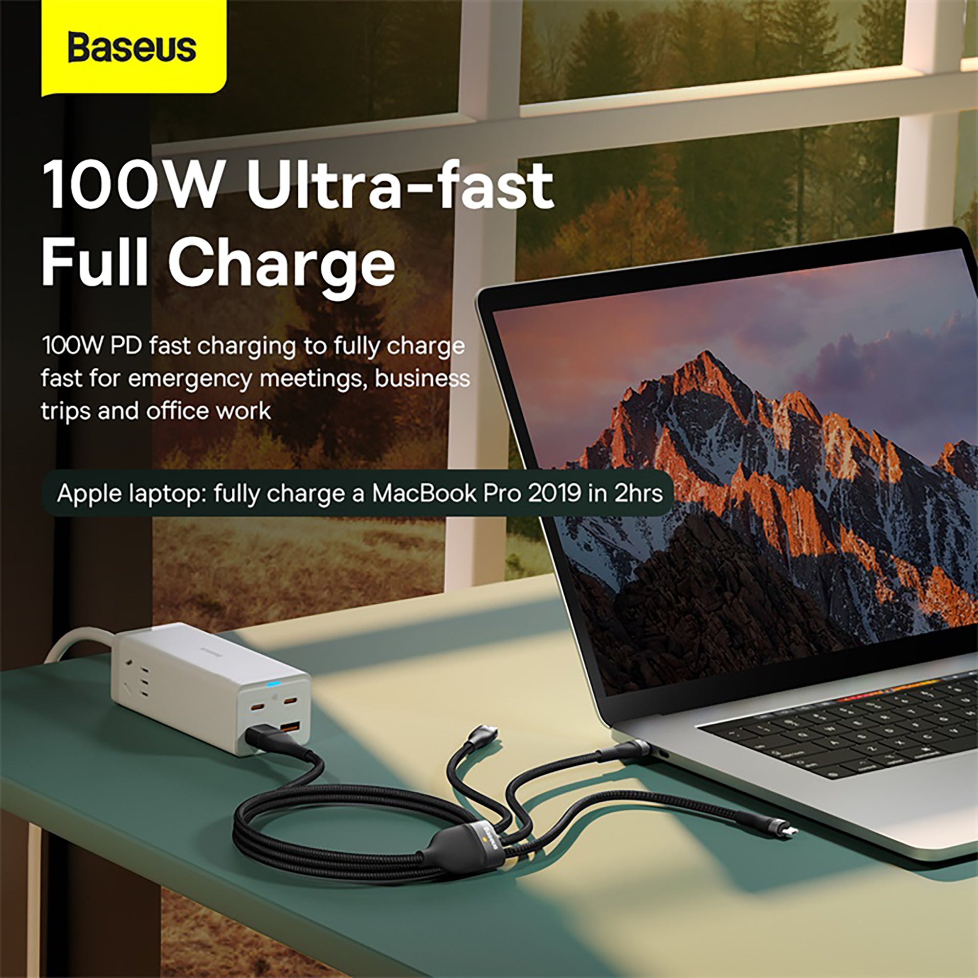 Laptop being charged with a Baseus charger on a desk, with scenic background