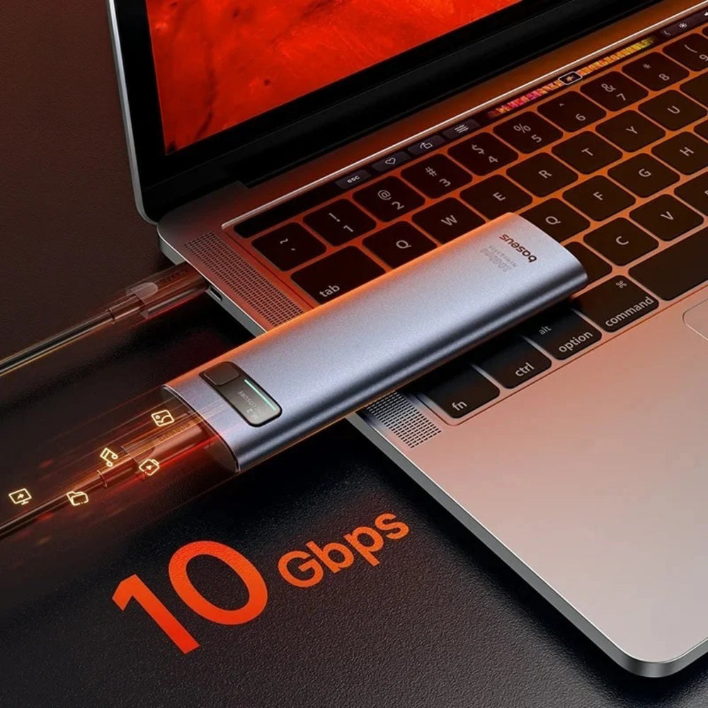 A silver and clear USB dongle device labeled 'shingoo' is shown plugged into a laptop keyboard, with glowing orange text reading '10 Gbps' on a dark surface.