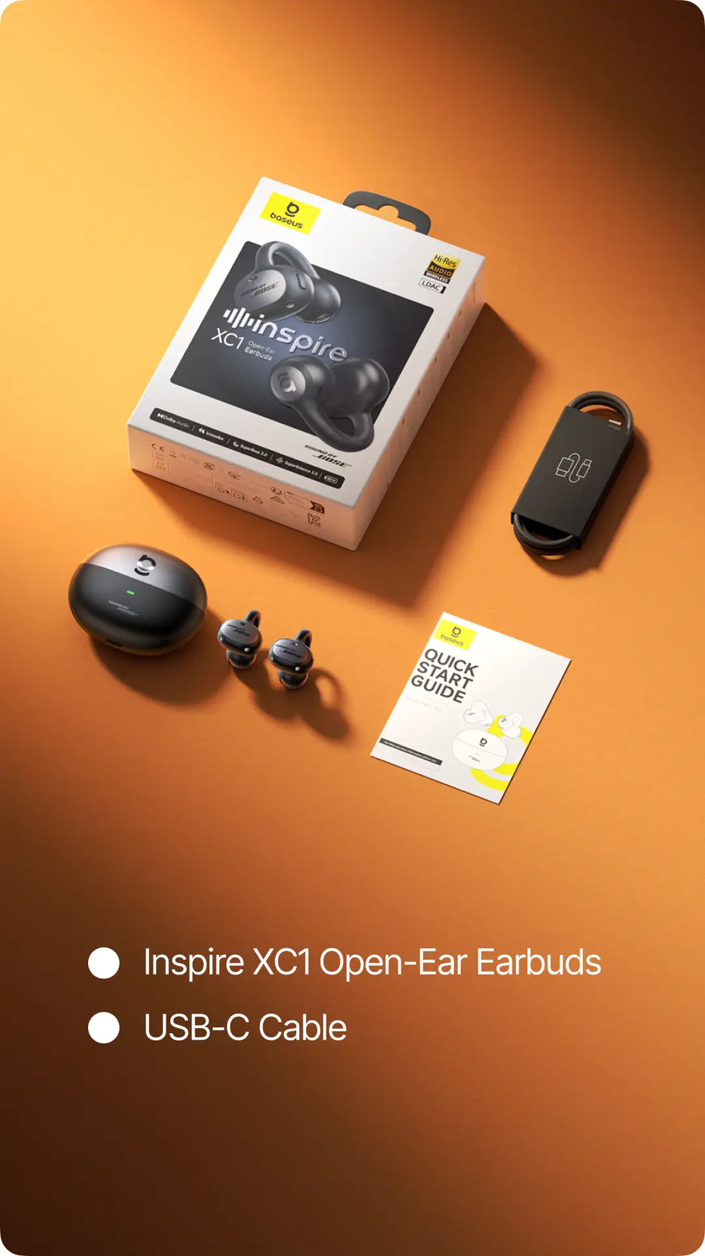 Whinspire open-ear earbuds with packaging, USB-C cable, and quick start guide on an orange background