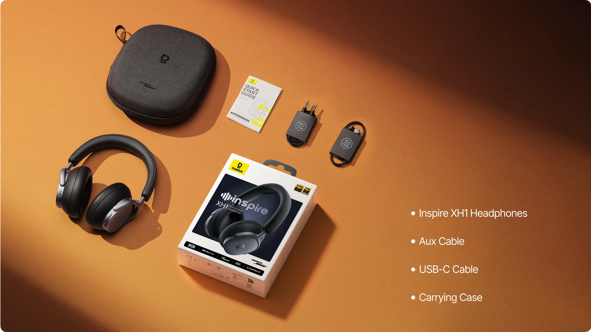 Waves Inspire XH1 headphones with packaging, carrying case, aux cable, and USB-C cable on an orange background.